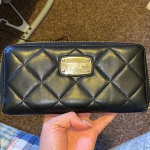 Black woman’s Michael Kors wallet leather  quilted